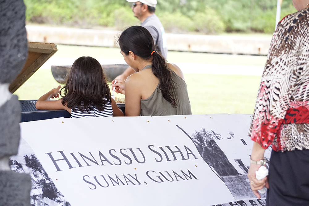 People attend a ceremony at Sumay